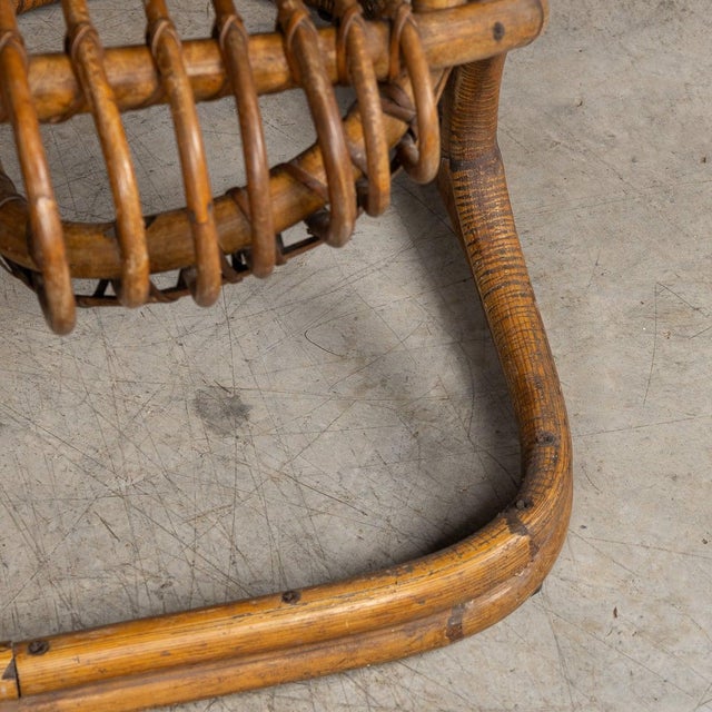 A striking pair of wicker armchairs by renowned italian designer tito agnoli that encapsulate the elegance and natural...