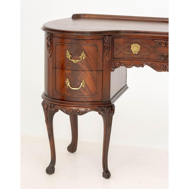 Queen Anne Style Mahogany Kidney Shaped Desk, the central drawer flanked by two rows of two drawers above cabriole legs....
