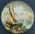 Item description: Majolica ceramic plate decorated entirely by hand by the artist depicting a landscape, specifically a...