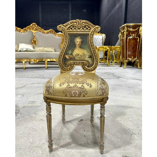 Elevate your home décor with this exquisite French Rococo accent chair. Fully refinished with radiant gold leaf, it...