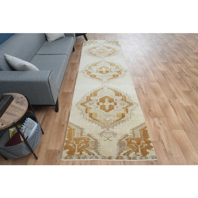 This vintage hand-knotted area rug is a semi-antique vintage area rug. The '70s Eastern region of Anatolian's unique rug...