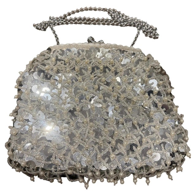 Step out in classic mid-century glamour with this authentic 1950s Italian evening bag. Featuring a lustrous white silk...