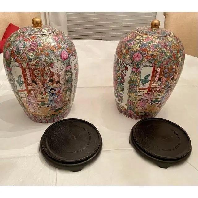 Offered is a vintage pair of large ginger jars. This set features a beautiful array of colors set on a wooden pedestal....