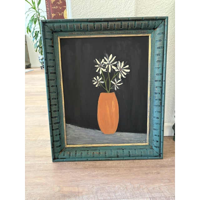 Whimsical rustic, vintage framed painting of zebra like daisies, silhouette against a black background. The frame is...