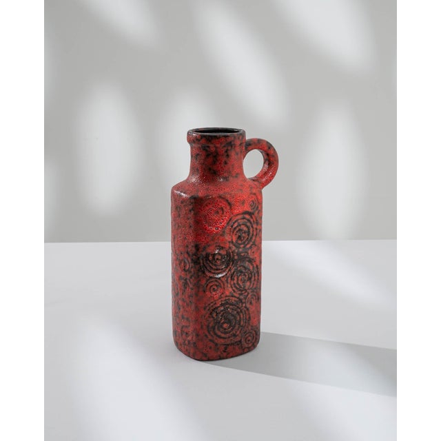 Indulge in the vibrant allure of this 1960s German "W. Germany" ceramic vase, a masterpiece boasting a captivating fat...