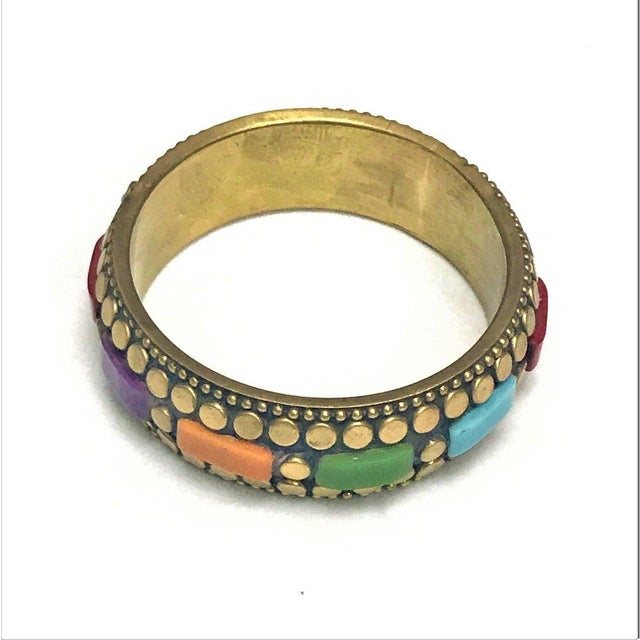 This elegant Art Deco-style bangle is a refined testament to the movement’s love of geometry, color, and metallic...