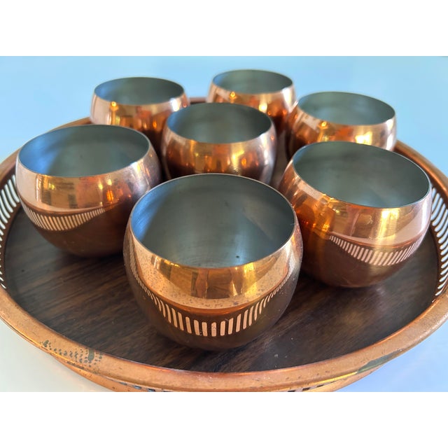 Vintage Coppercraft Guild set of 7 cups and one serving try. The set is in very good vintage condition. Could be polished...