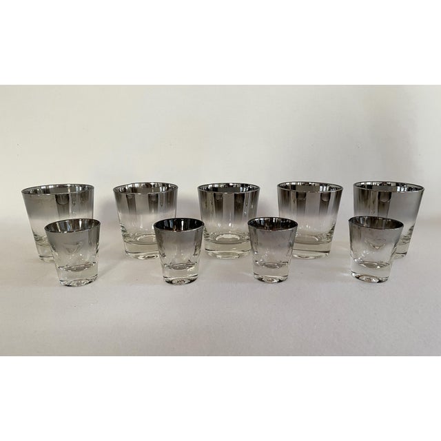 A set of 8 Dorothy Thorpe cocktail glasses. The silver rim glasses includes 4 rocks glasses and 4 shot glasses, perfect...