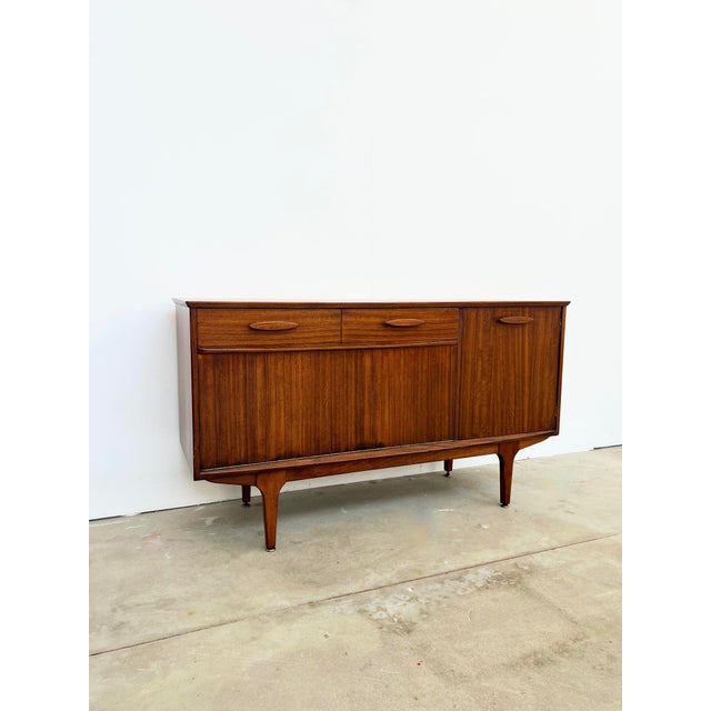 Low sideboard by jentique, an english manufacturer with danish influences, dating from the 1950s-60s. Made of warm, deep...