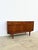 Low sideboard by jentique, an english manufacturer with danish influences, dating from the 1950s-60s. Made of warm, deep...