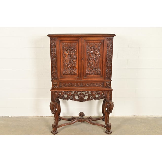 A gorgeous antique French Renaissance Revival bookcase, cupboard, or bar cabinet In the manner of R.J. Horner & Co....