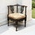 A 19th century Italian Renaissance Revival corner armchair carved from solid walnut, finished in a deep, lustrous patina...