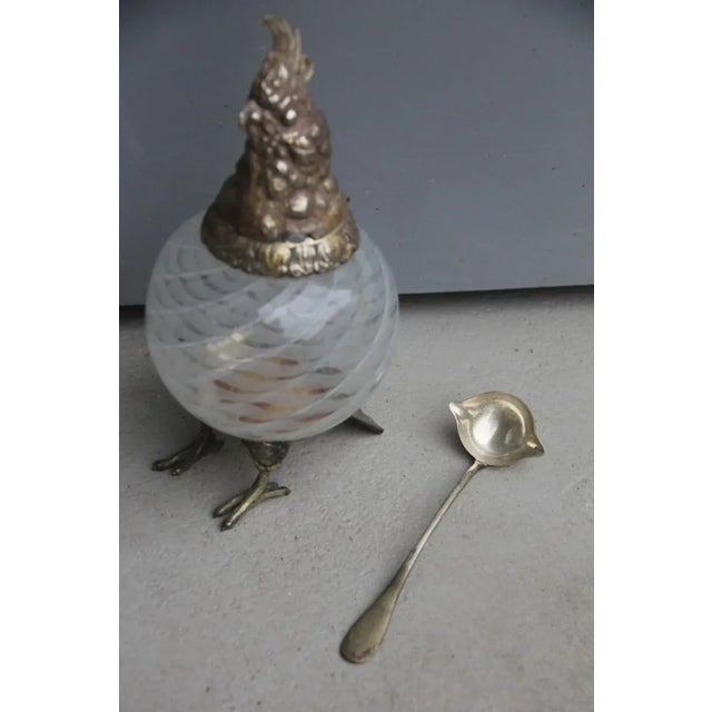 This bird container with lid is made of Murano glass with a chromed metal base.