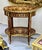 A stunning French Louis XV-style oval side table showcasing exceptional marquetry craftsmanship, elegant proportions, and...