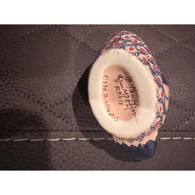 These charming, hand-painted ceramic ducks are identified by the Henriot Quimper mark on their base, a historic French...