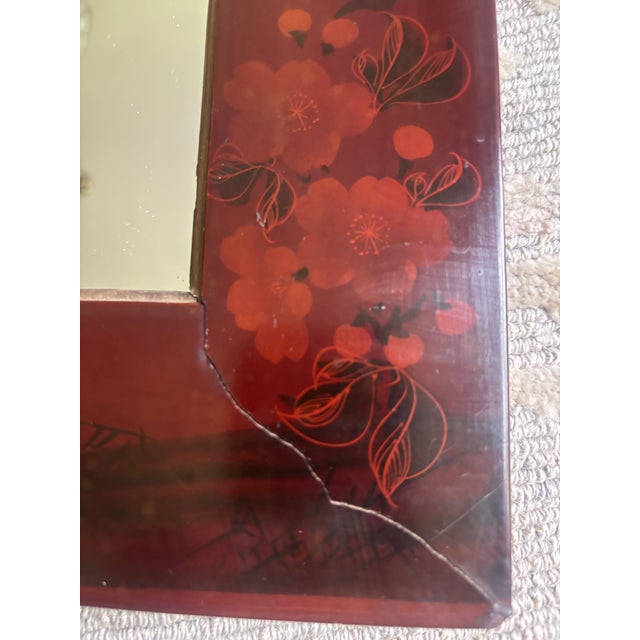 An Aesthetic Movement floral decorated mirror with a Chinese red lacquer base and Asian-inspired floral decoration all...