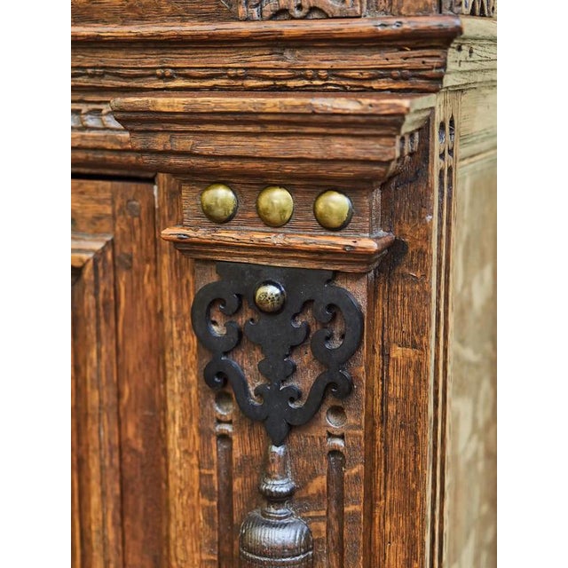 Original Flemish Renaissance cabinet carved from solid oak. The facade is decorated with geometric coffers, plastic...