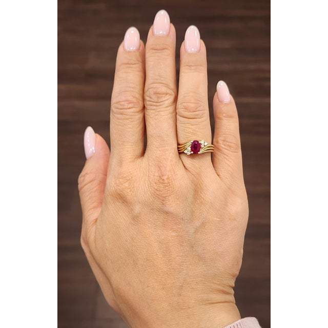 This stunning ruby and diamond ring is a timeless expression of elegance, beautifully crafted in 14k yellow gold. At its...