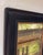 This oil on panel depicts a serene scene beneath a weathered bridge, where soft light filters through the foliage,...
