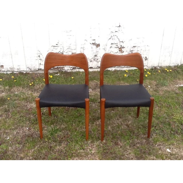 Add timeless elegance to your space with this stunning pair of vintage Danish Modern dining chairs. Crafted from rich teak...