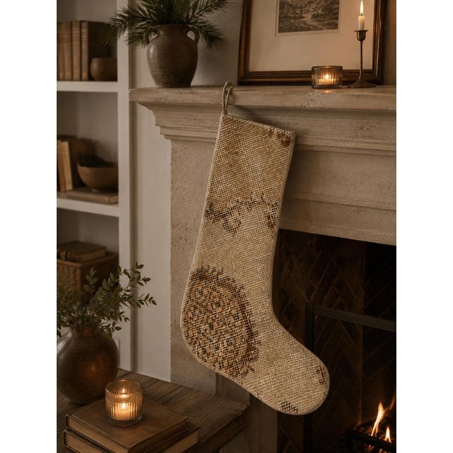 This vintage wool kilim stocking has a soft, sun-faded ivory ground with just a whisper of rust brown pattern remaining...
