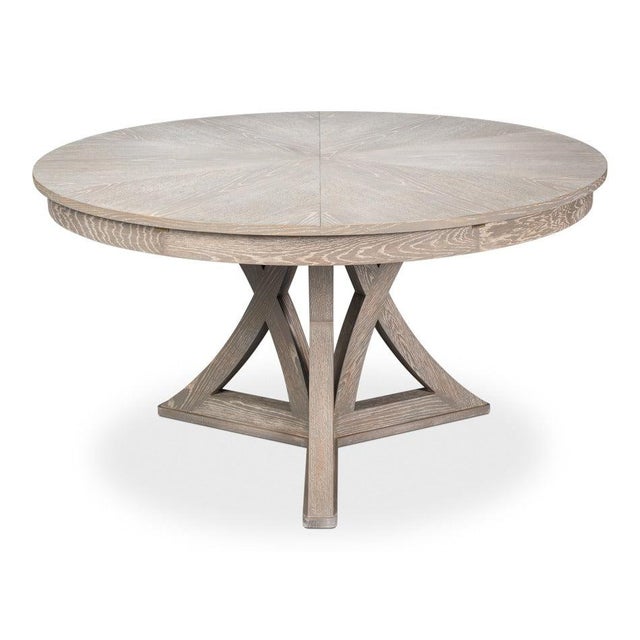 An open, angled base brings architectural structure to the broad circular top without a strong color statement. Four...