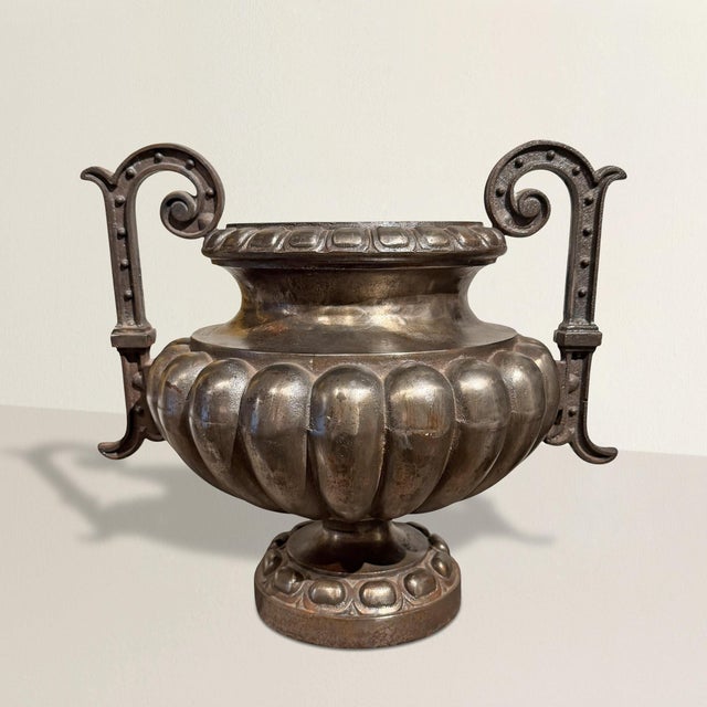 This French cast metal urn dates to the 20th century, a measured homage to the original 19th century Napoléon III models,...