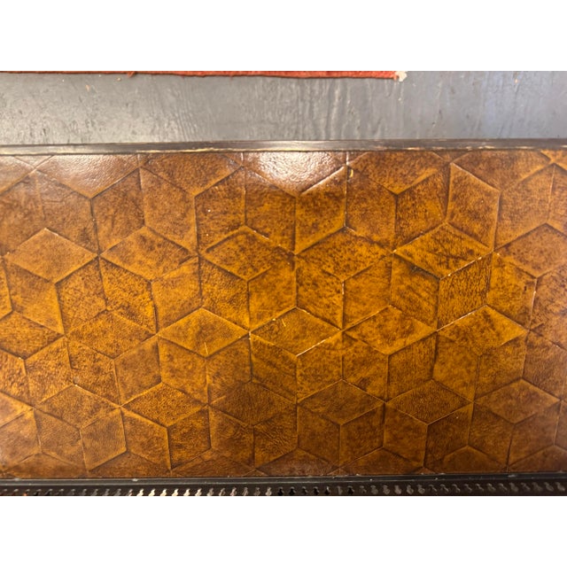 This is an elegant leather top console table designed by Theodore Alexander. It has neoclassical style. The leather top...