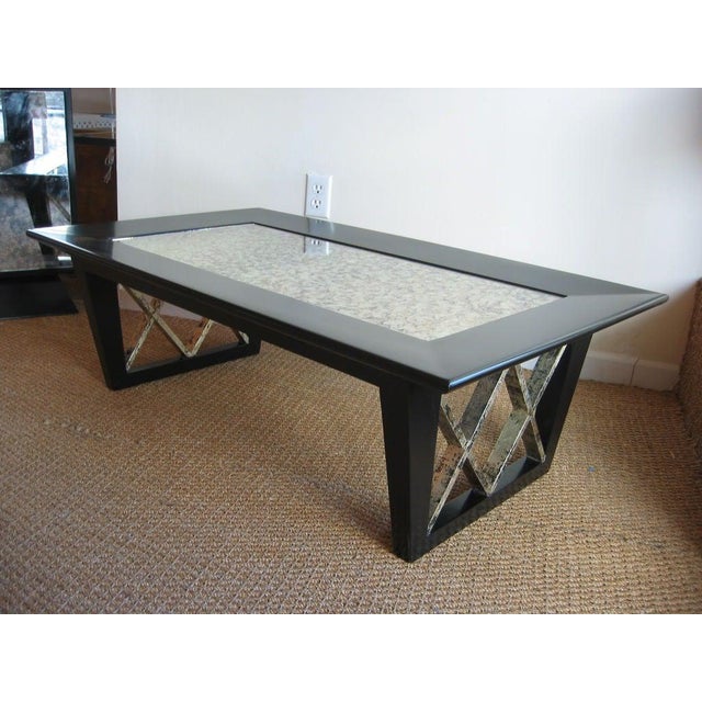 This vintage 1950's wonderful cocktail table was re- finished in black satin with inverted X frame rubbed silver leafed...