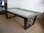 This vintage 1950's wonderful cocktail table was re- finished in black satin with inverted X frame rubbed silver leafed...