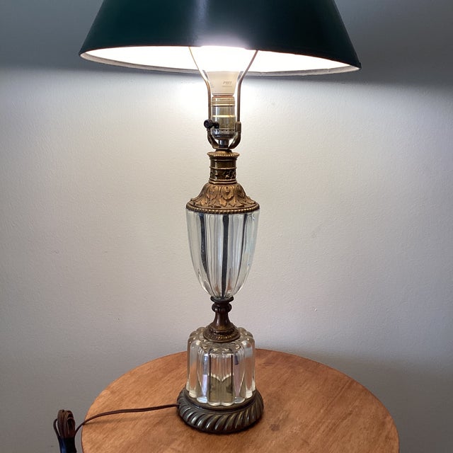 This Hollywood Regency lamp features a stunning crystal-tiered ribbed glass design with bronze fittings, typical of the...