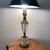 This Hollywood Regency lamp features a stunning crystal-tiered ribbed glass design with bronze fittings, typical of the...
