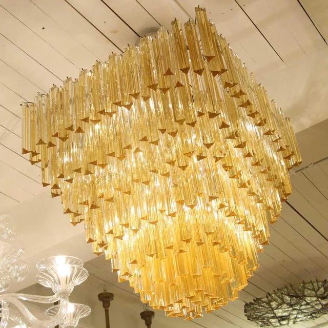 An outstanding ceiling light, amber and clear submerso blown TRIEDRI glass components on chromed steel structure. Made in...