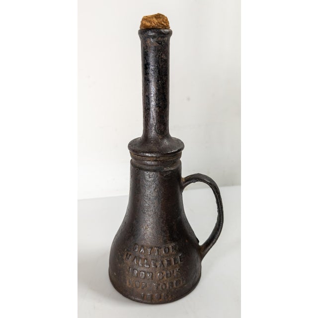 We are selling this cool cast iron torch. This torch has cool form and simple design. It is marked Dayton Malleable Iron...