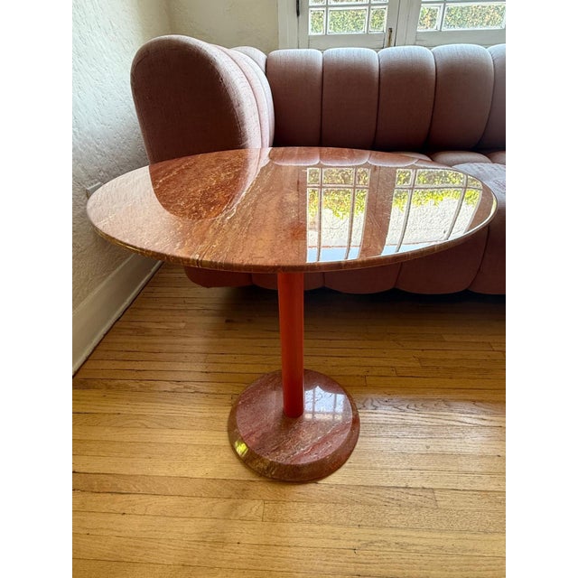 Red travertine side table with lacquered red metal foot