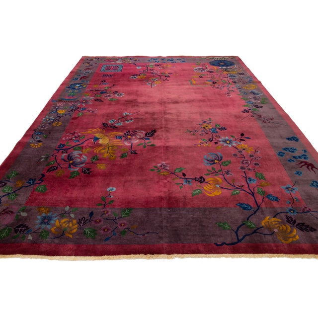 This stunning antique Chinese Art Deco rug is expertly hand-knotted from premium wool. It features a rich burgundy-red...