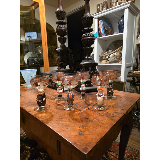 Charming never used still in the original box West German figural porcelain and gilt etched glass drinking vessels. Each...