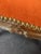 A French Carved Walnut Footstool Newly Updated and Covered in Orange Velvet with Nailhead Trim.