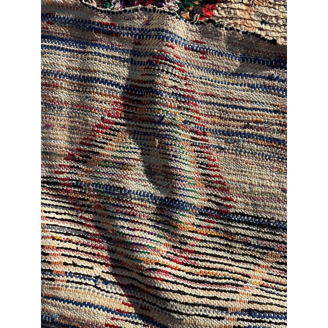 This authentic Berber Azilal runner rug is a handmade Moroccan piece, woven using a traditional mix of natural wool and...