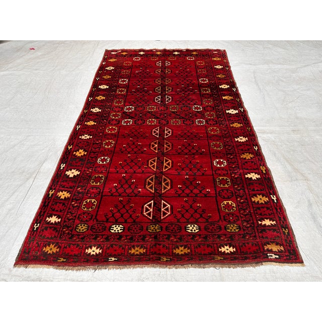 This antique hand-knotted Ersari Turkmen rug features a column of compartmentalized tree panels divided by horizontal...