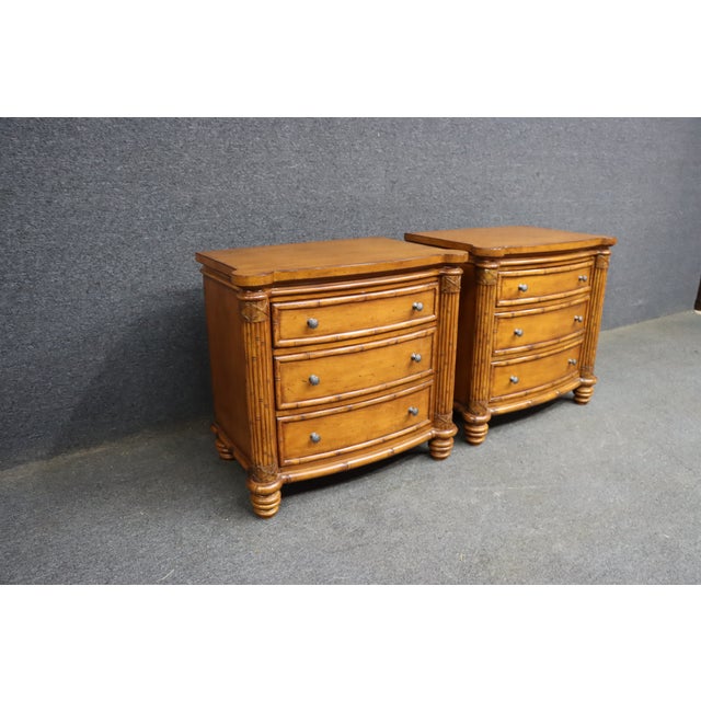 A substantial pair of Tommy Bahama Home Island Estate Barbados nightstands in the Plantation finish. Each nightstand...
