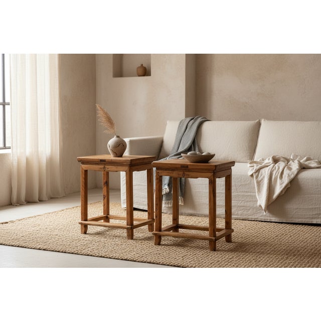 A timeless example of Chinese provincial carpentry, this matching pair of rectangular stools is crafted from solid Yumu...