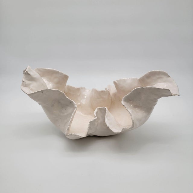 This hand-sculpted pottery bowl exudes elegance and grace. Its organic form echoes nature, making it a stunning...