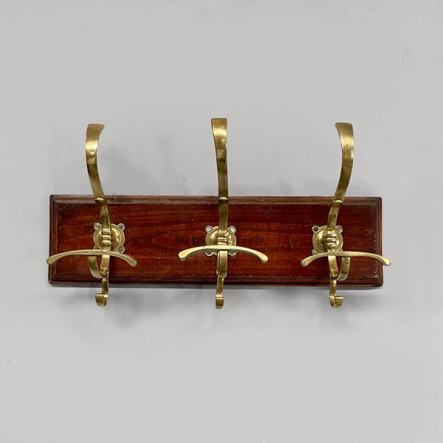 Italian Art Nouveau wall coat rack in wood and brass, 1920s Wall coat rack with three brass S-hooks. Rectangular wooden...
