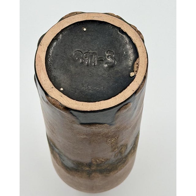 This elegant ceramic vase features a sophisticated volcanic glaze in earthy brown tones, showcasing the iconic "Fat Lava"...