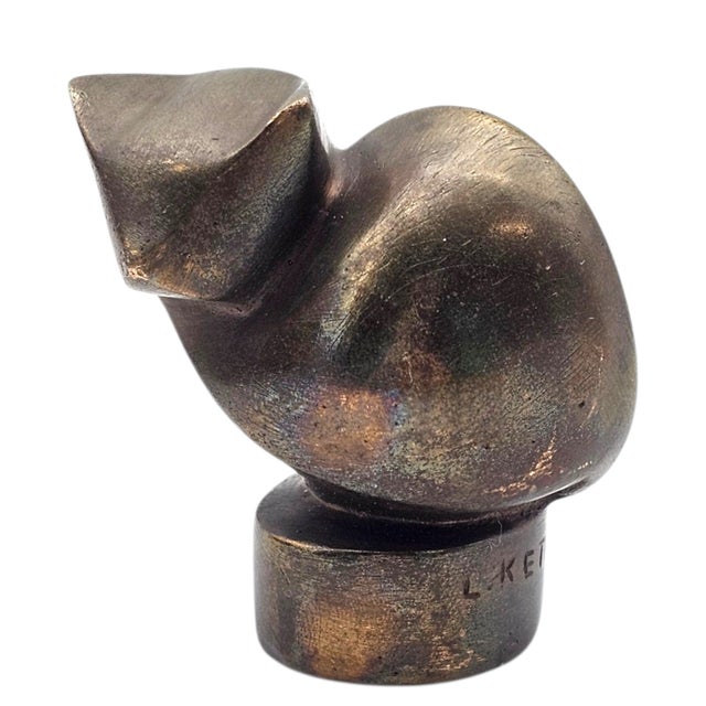 This solid bronze cat sculpture is a signed work by Lies Ketterer 1905-1976, featuring a hand-incised artist signature...
