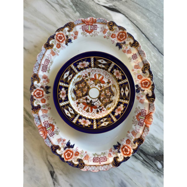 Here is a fine antique serving platter by Samuel Radford, Ltd. In a floral cobalt and persimmon pattern with Greek key...