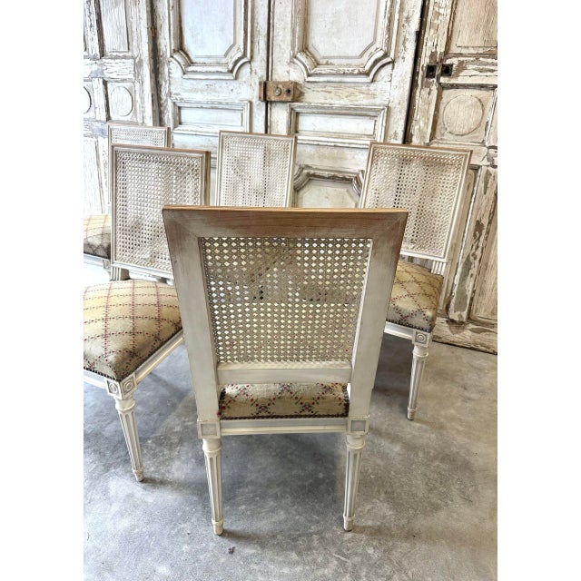 A set of six lacquered and painted azure blue louis xvi style chairs, dating from the mid-20th century. The legs are...