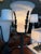 A Haig table lamp featuring a carved alabaster urn supported by decorative bronze leaf-form accents and a fluted column...