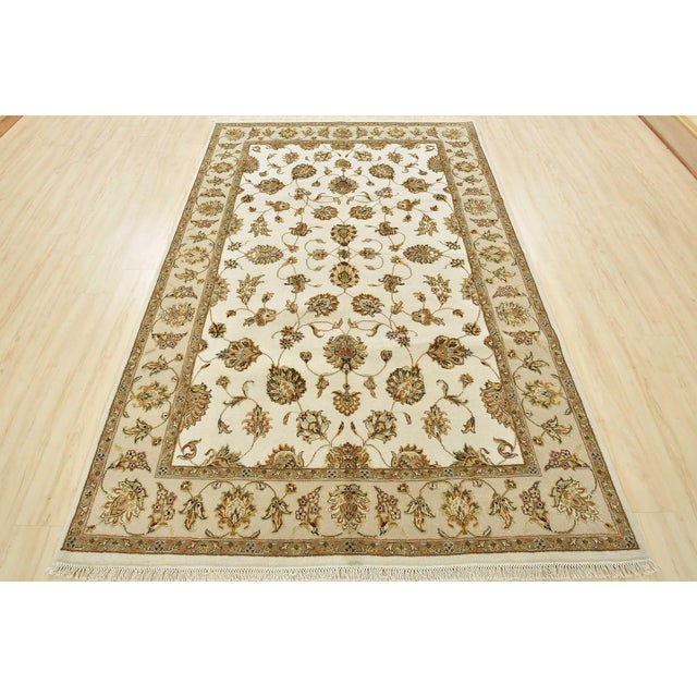 This fine traditional Agra rug is hand-knotted with a wool and silk pile on a cotton foundation. This rug is new and in...